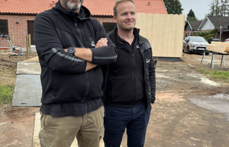 To mænd står foran de nye boliger på Toften i Padborg