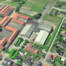 Luftfoto over Broager med Broagerhallen og de omkringliggende parkeringsarealer.