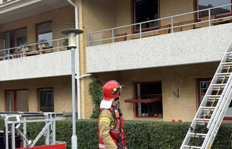 Brandmand går ved stigen op til altanen under branden i Domhusparken